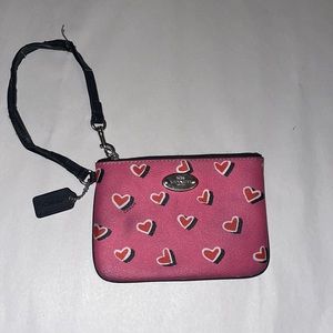 Pink coach coin purse with red heart design